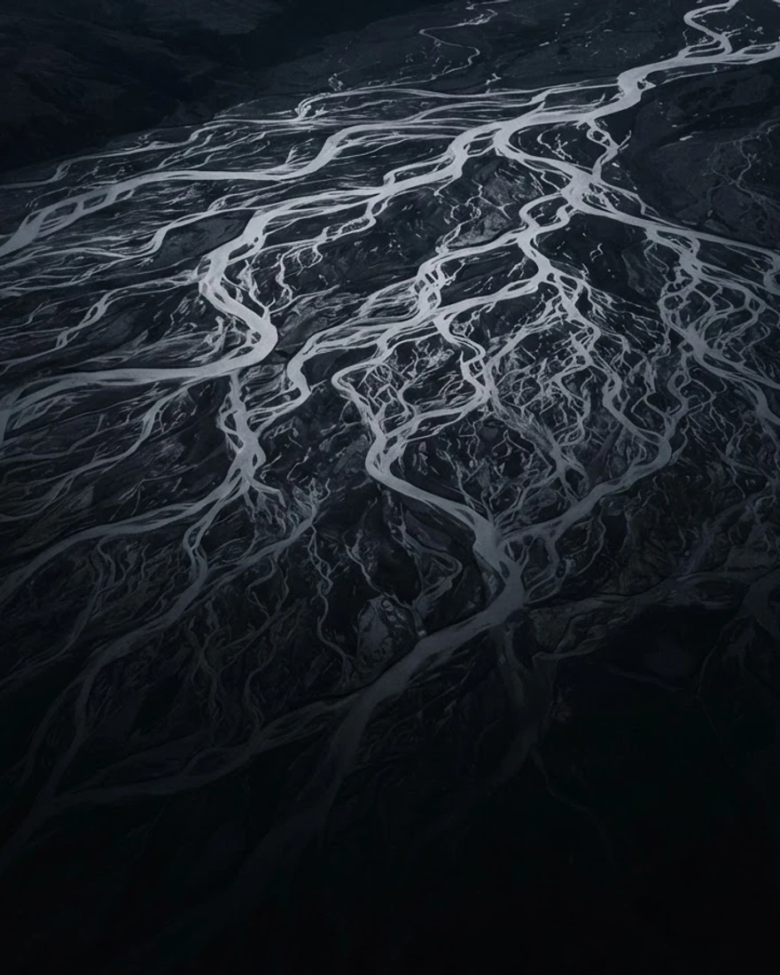 Aerial night view of a vast river delta reflecting moonlight